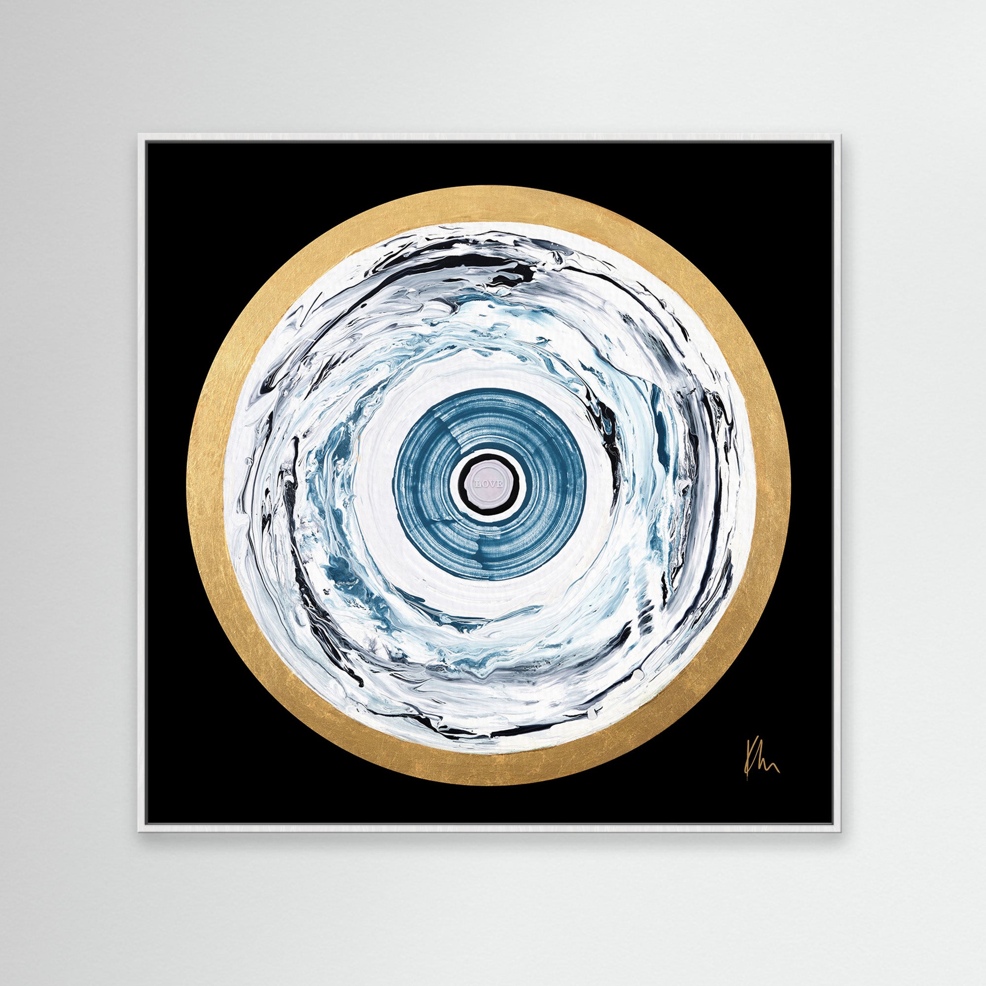 The "One Love" print by Kate Mayer showcases abstract artwork with a circular pattern in blue and white tones, encircled by a gold outer ring against a black background. This piece harmoniously blends vibrant colors, creating art that captivates the heart.