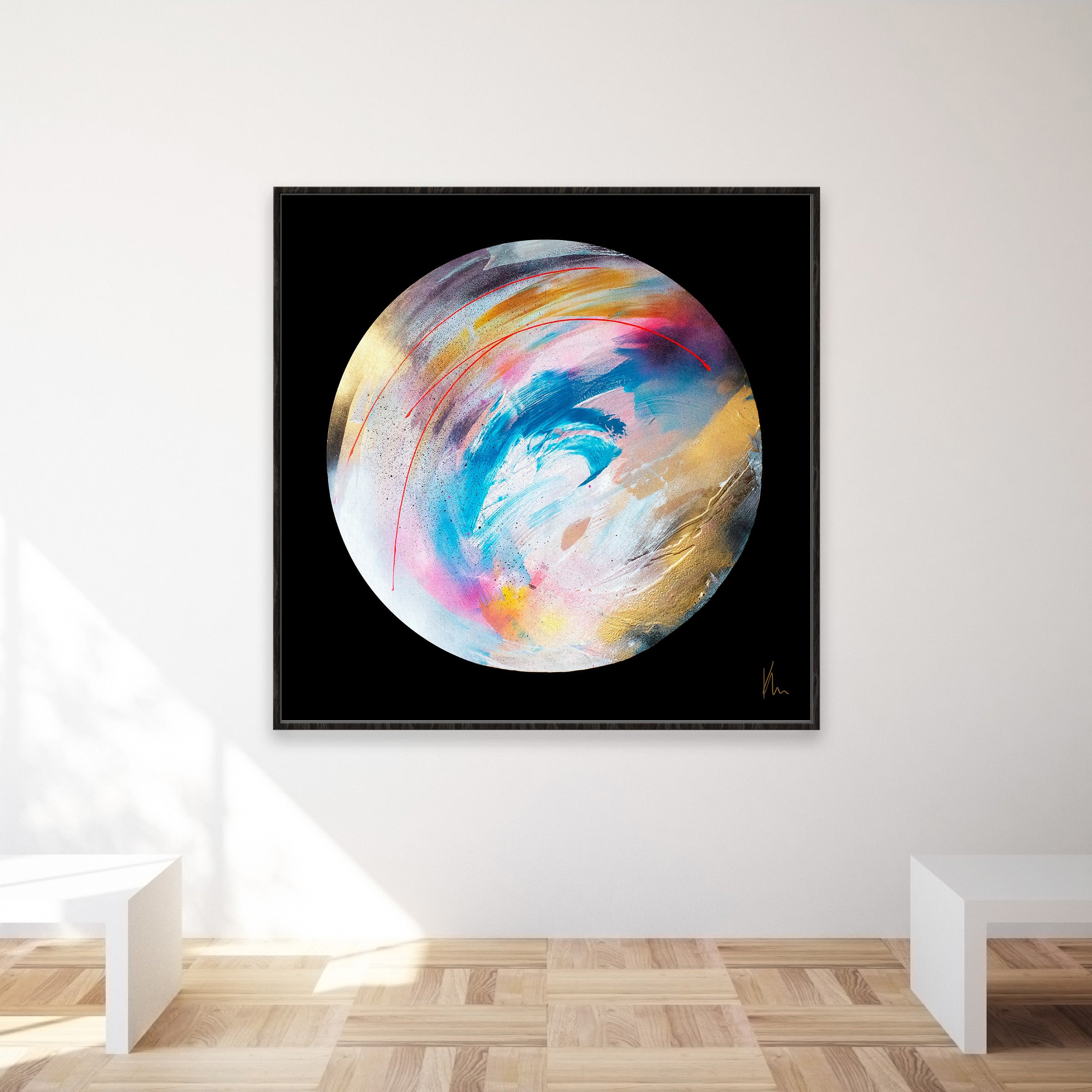 The painting titled "Speak Your Truth" by Kate Mayer, showcasing abstract art of a planet with vibrant brushstrokes of blue, pink, yellow, and white on a black background, is mounted on a white wall. This piece beautifully captures the dynamic interplay of colors and textures.