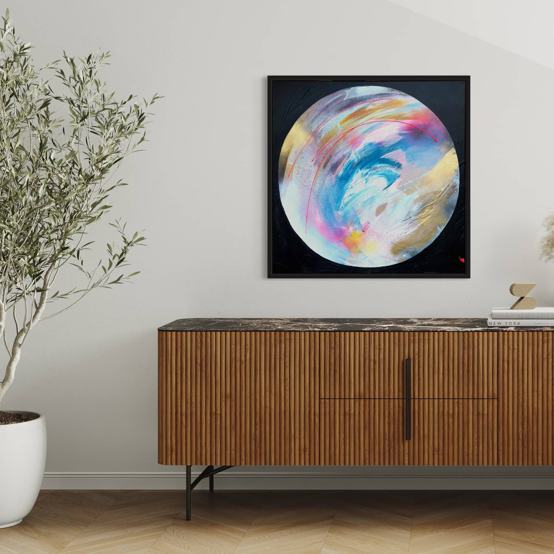 A modern living room with a wooden cabinet, "Speak Your Truth" by Kate Mayer on the wall, a potted plant, and a decor urn on the cabinet.