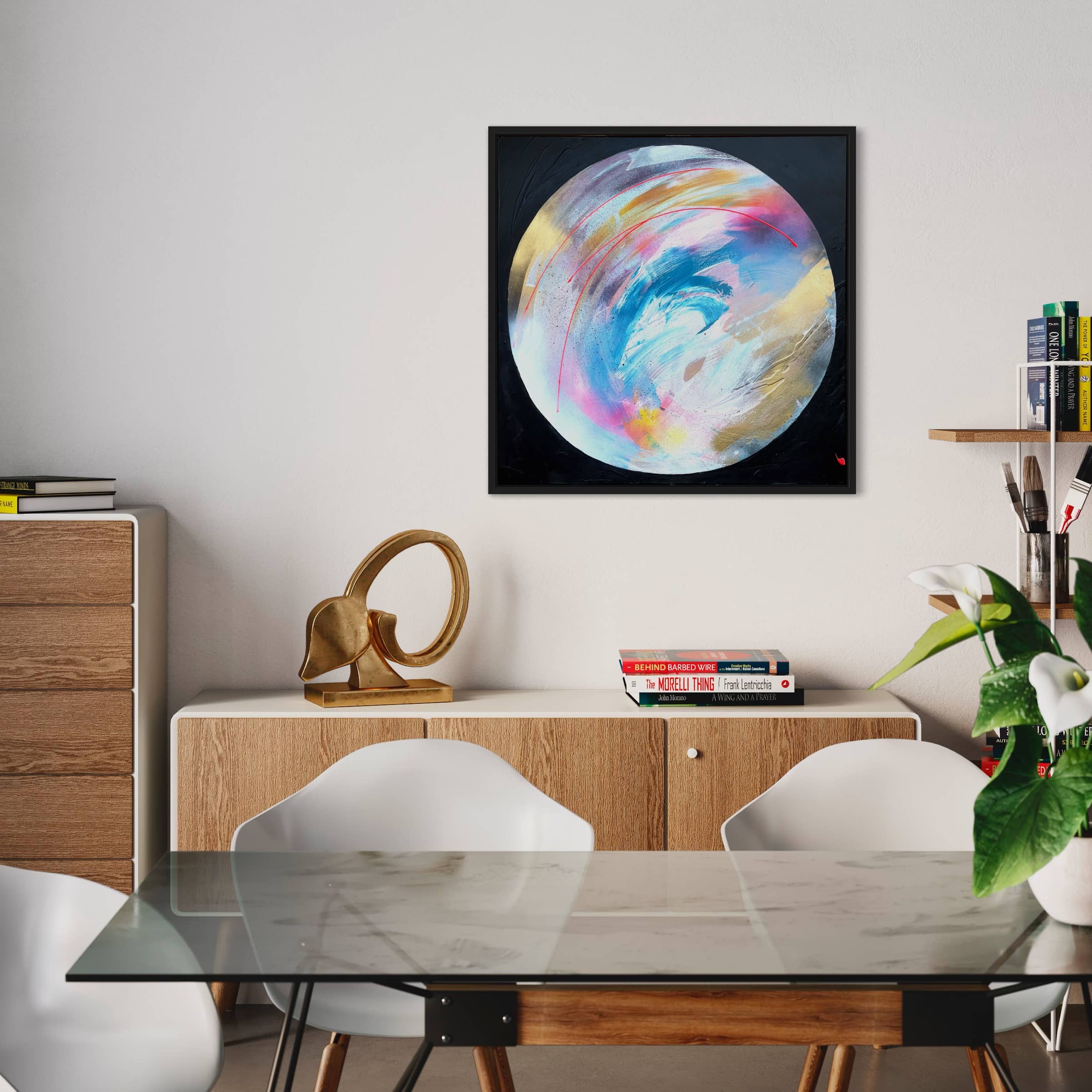 A contemporary dining space boasts a sleek glass table, minimalist chairs, and a chic wooden sideboard. The standout feature is Kate Mayer's vibrant abstract artwork titled "Speak Your Truth," enhancing the wall with its dynamic presence.