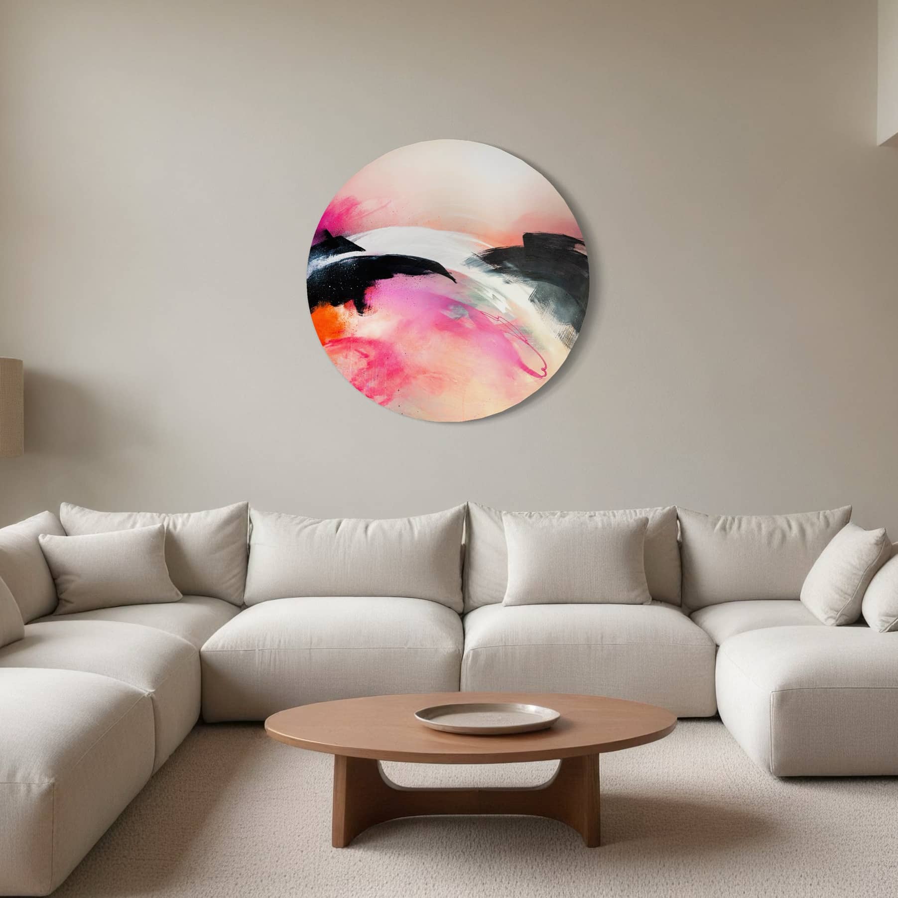 Minimalist living room with Kate Mayer's "It's A New Dawn" painting in a bespoke frame above a gray sectional and wooden table.