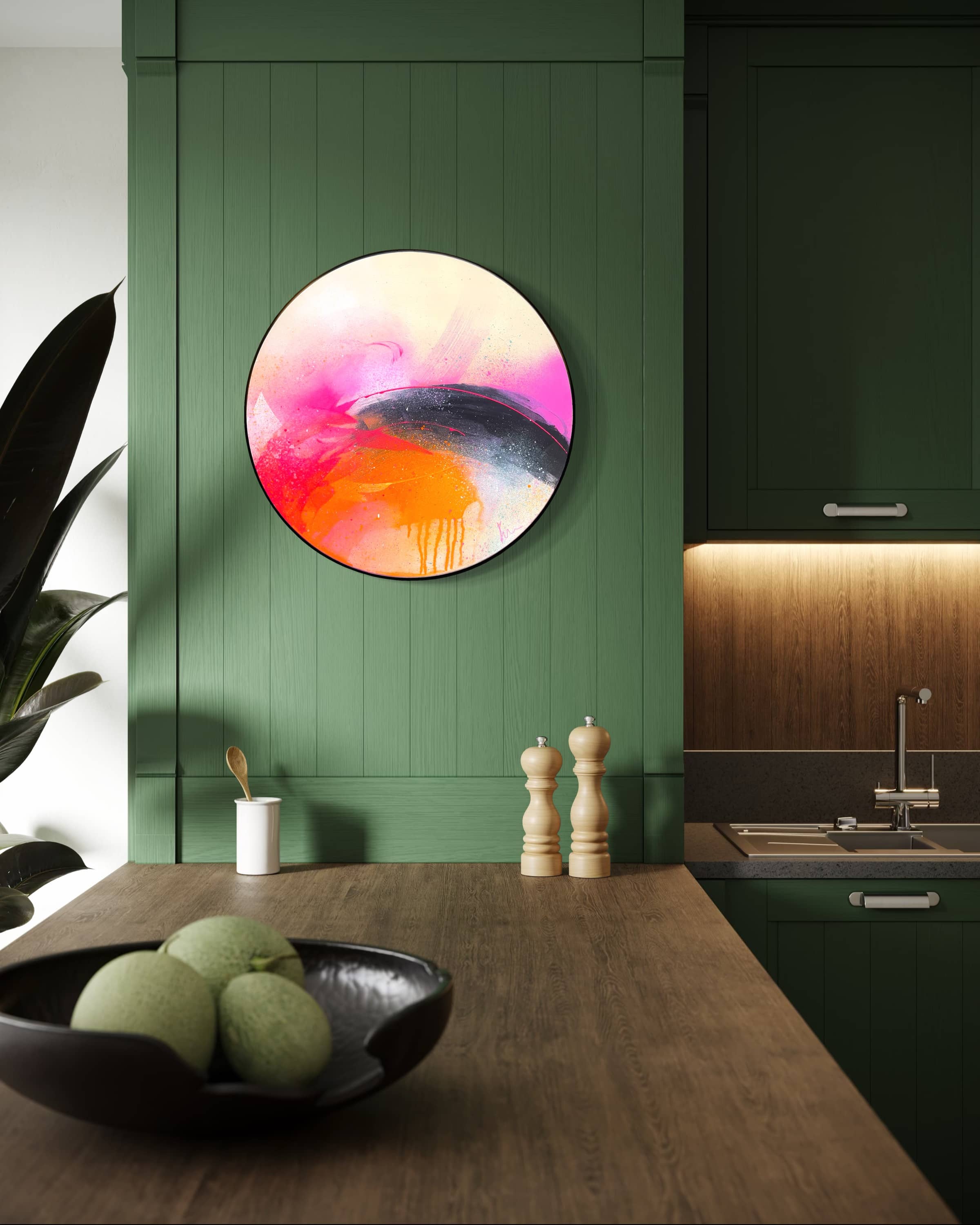 A modern kitchen with green cabinets, wood counter, and "I Carry On" by Kate Mayer acrylic art on the wall.