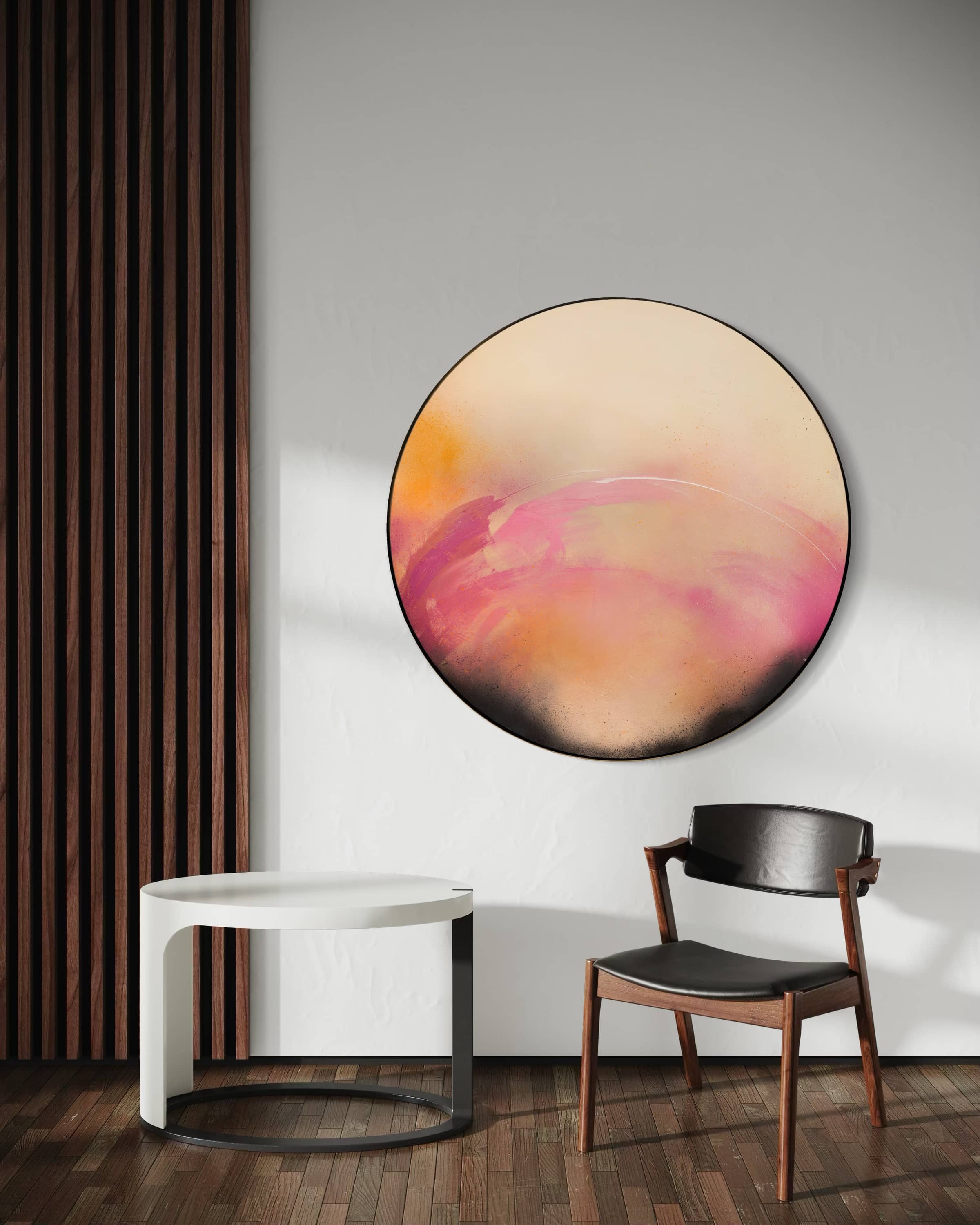 A modern room with "I Wait With Good Intentions" by Kate Mayer, a white table, and a wood chair with black seat.