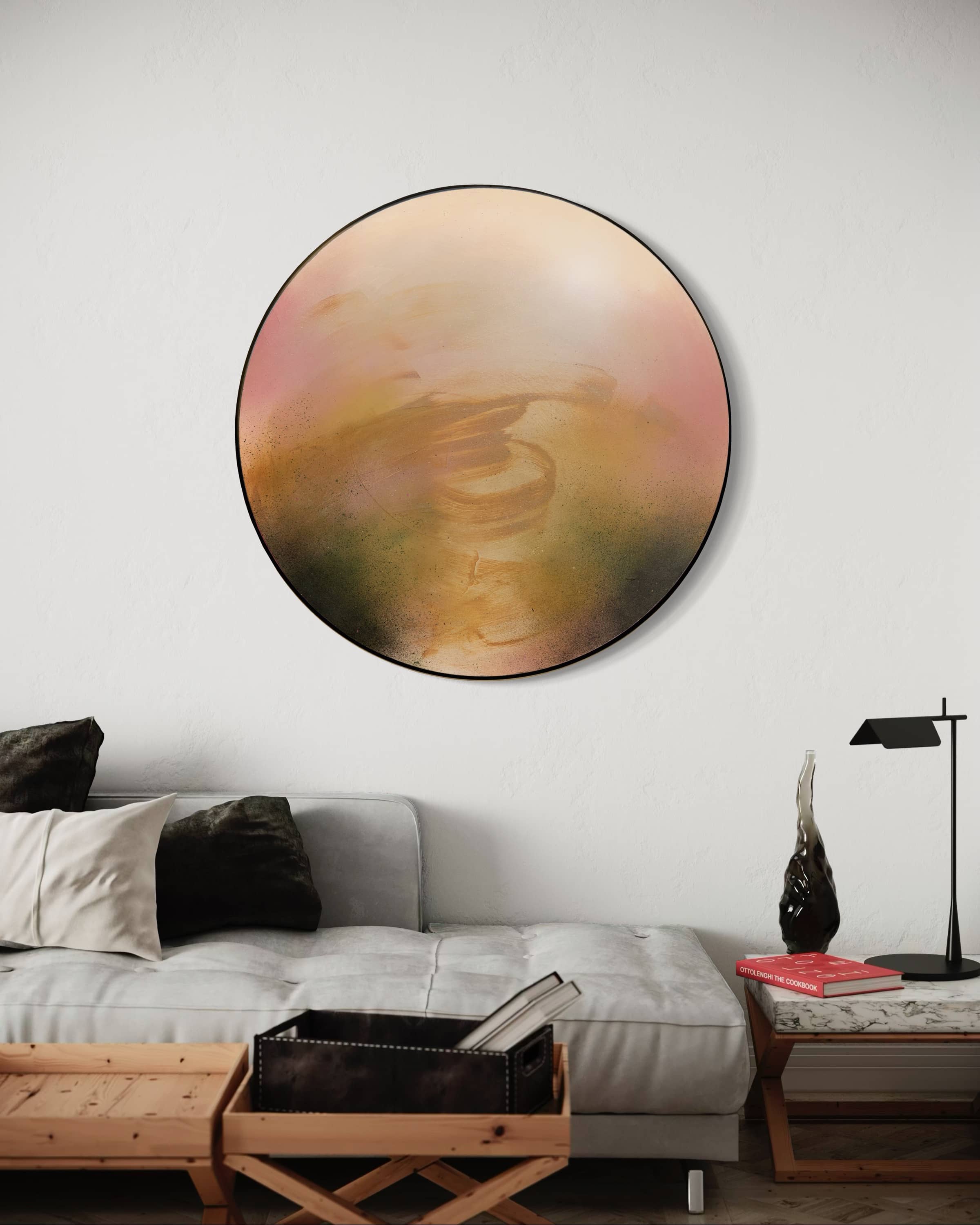 A modern living room with a gray sofa and "Kindling," a large circular artwork by Kate Mayer, above it.