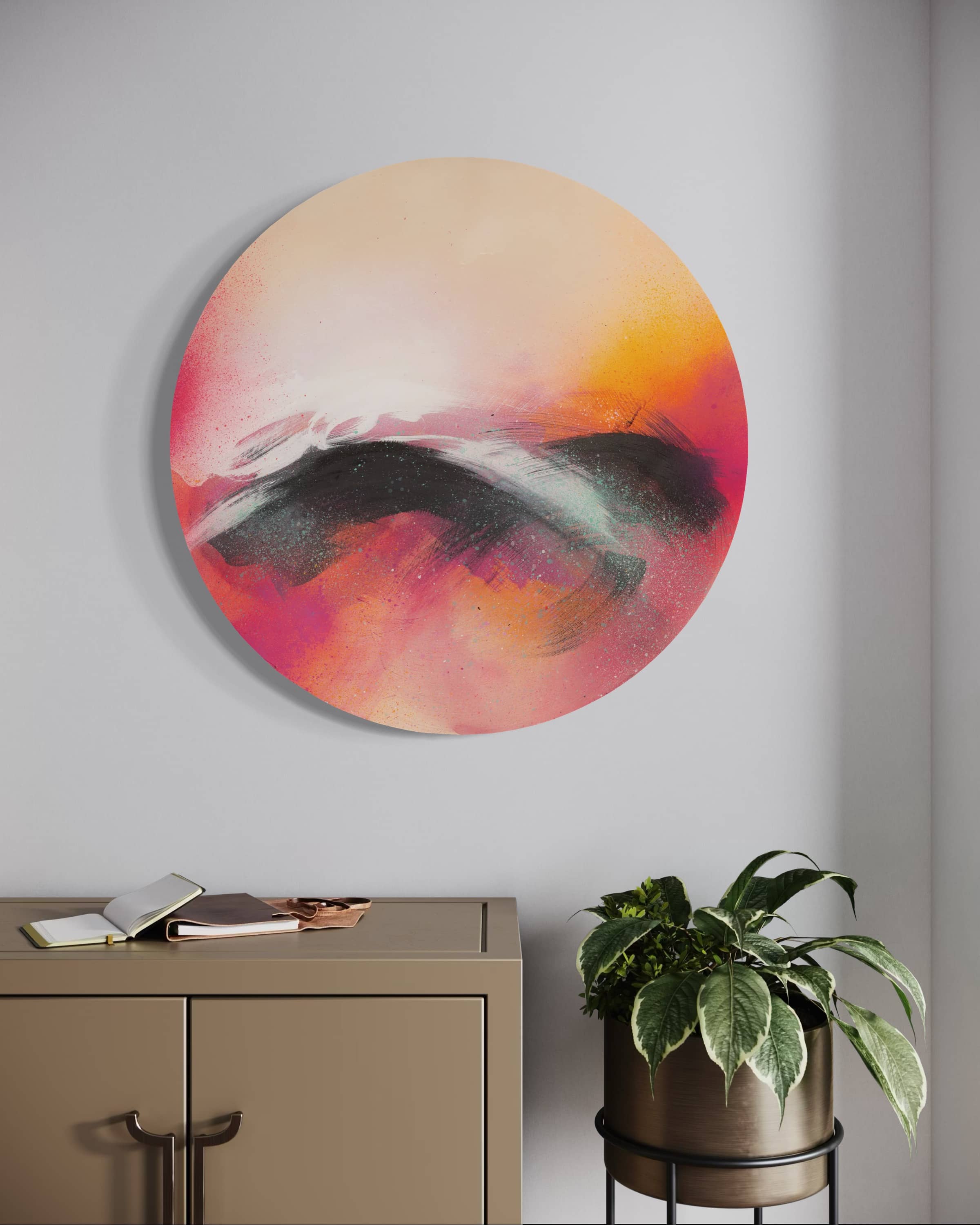 Optimistic" by Kate Mayer, a round abstract painting, hangs in a handmade metal float frame above a beige cabinet with a plant.