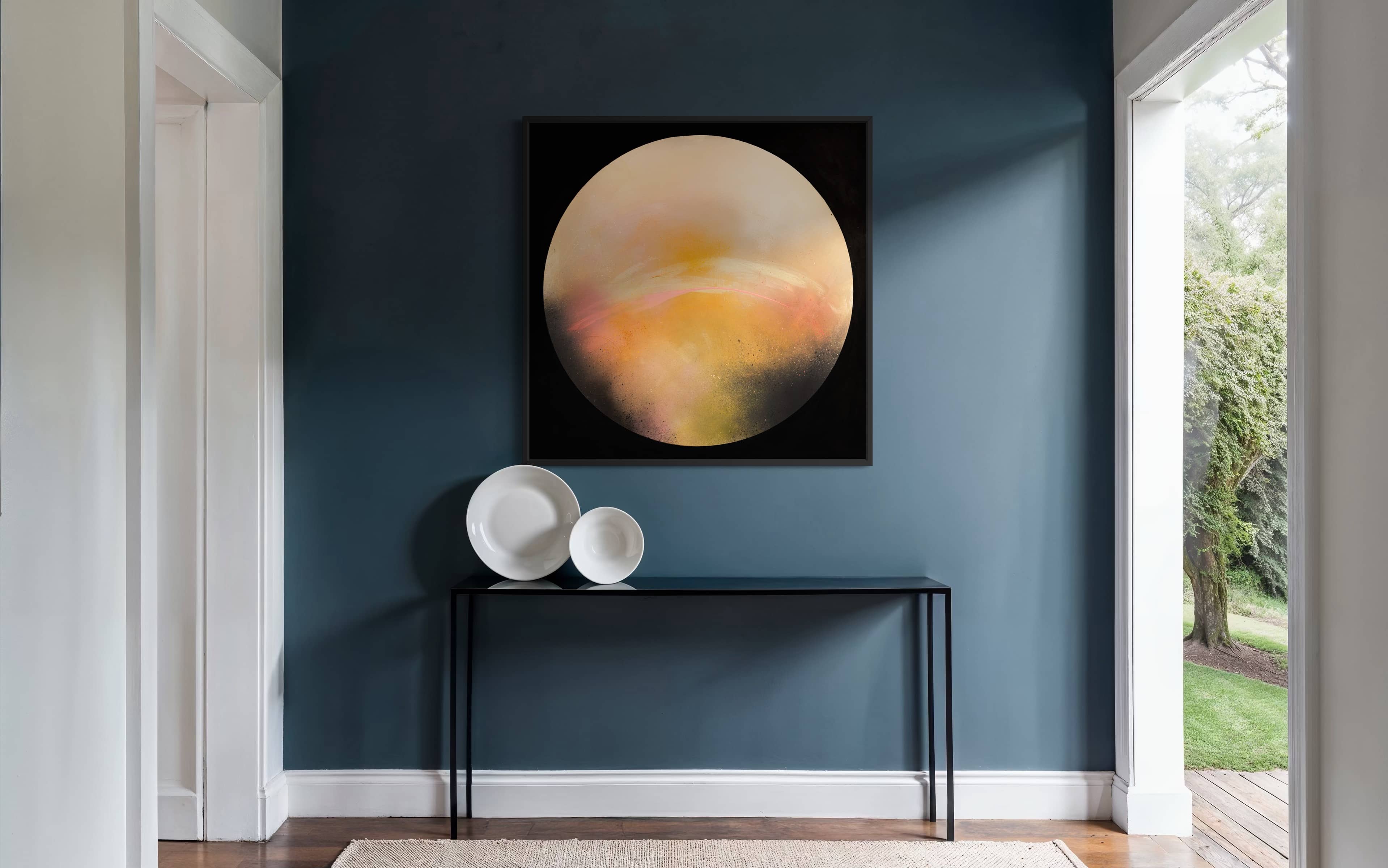 A modern hallway with blue walls, Kate Mayer's "Sun It Rises" painting on plywood, and white decorative bowls.