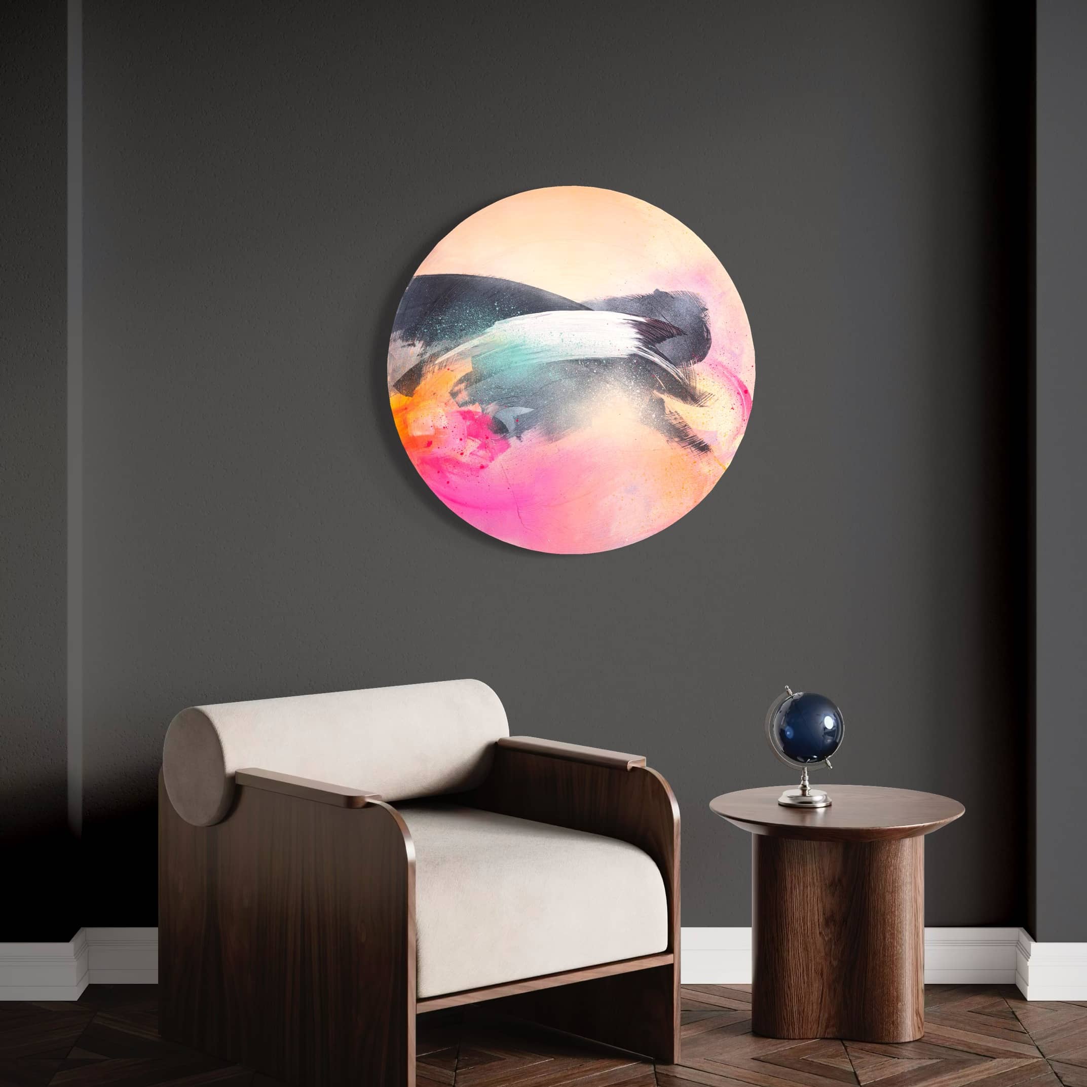 Glow Up by Kate Mayer, vibrant and circular, adorns a dark wall above a modern armchair and small round table.