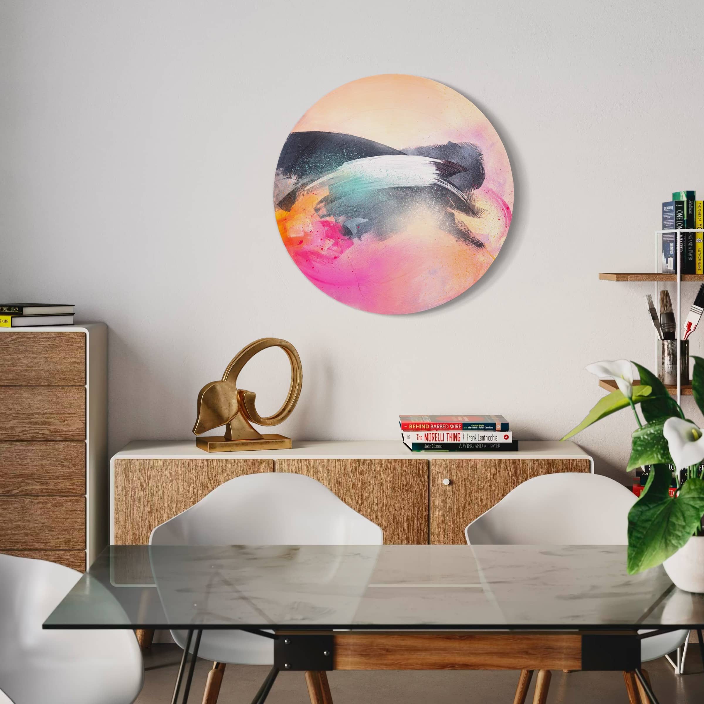 A modern dining room features a glass table, white chairs, and the Glow Up painting by Kate Mayer.