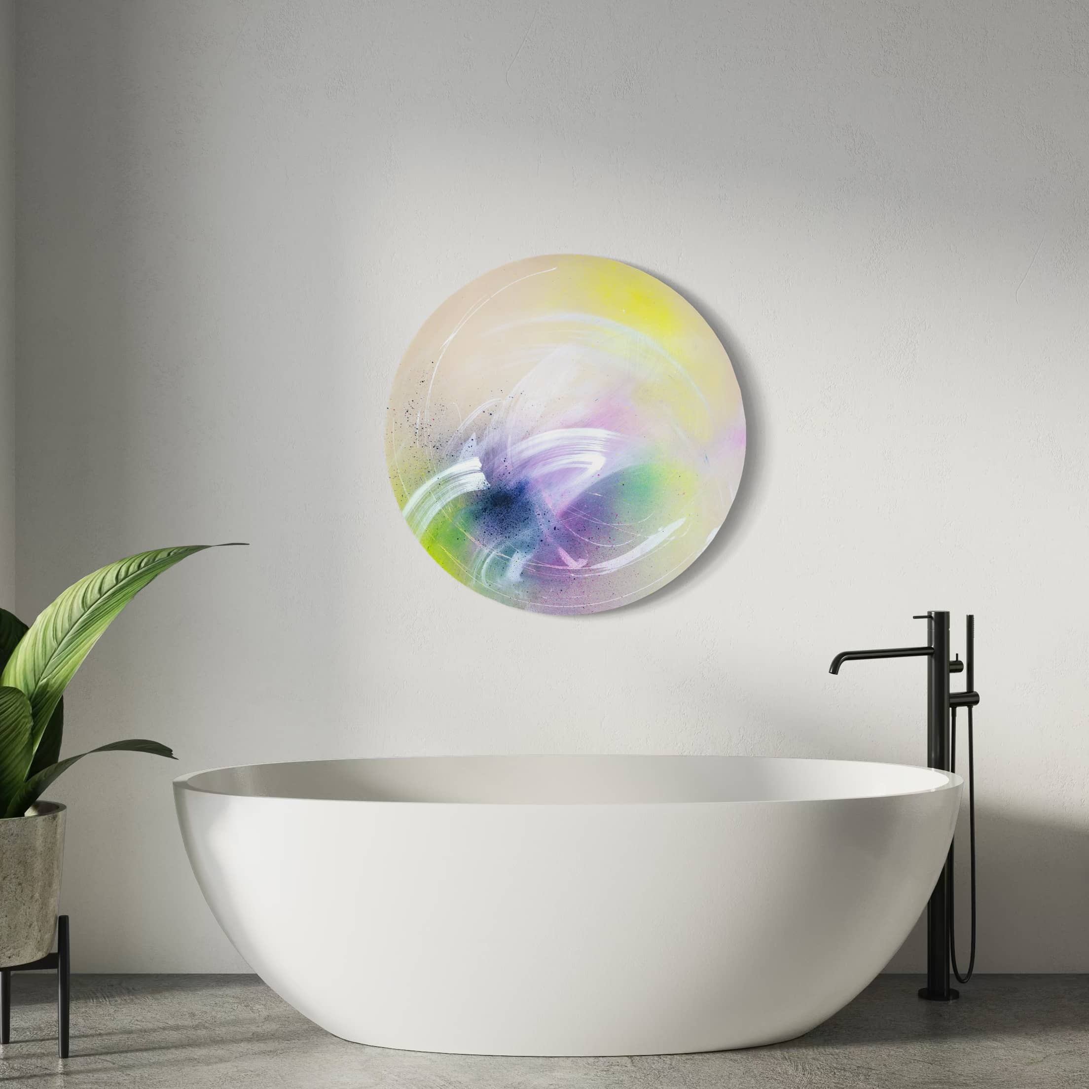 I Believe In Miracles" painting by Kate Mayer above bathtub in minimalistic bathroom with pastel tones and a potted plant.