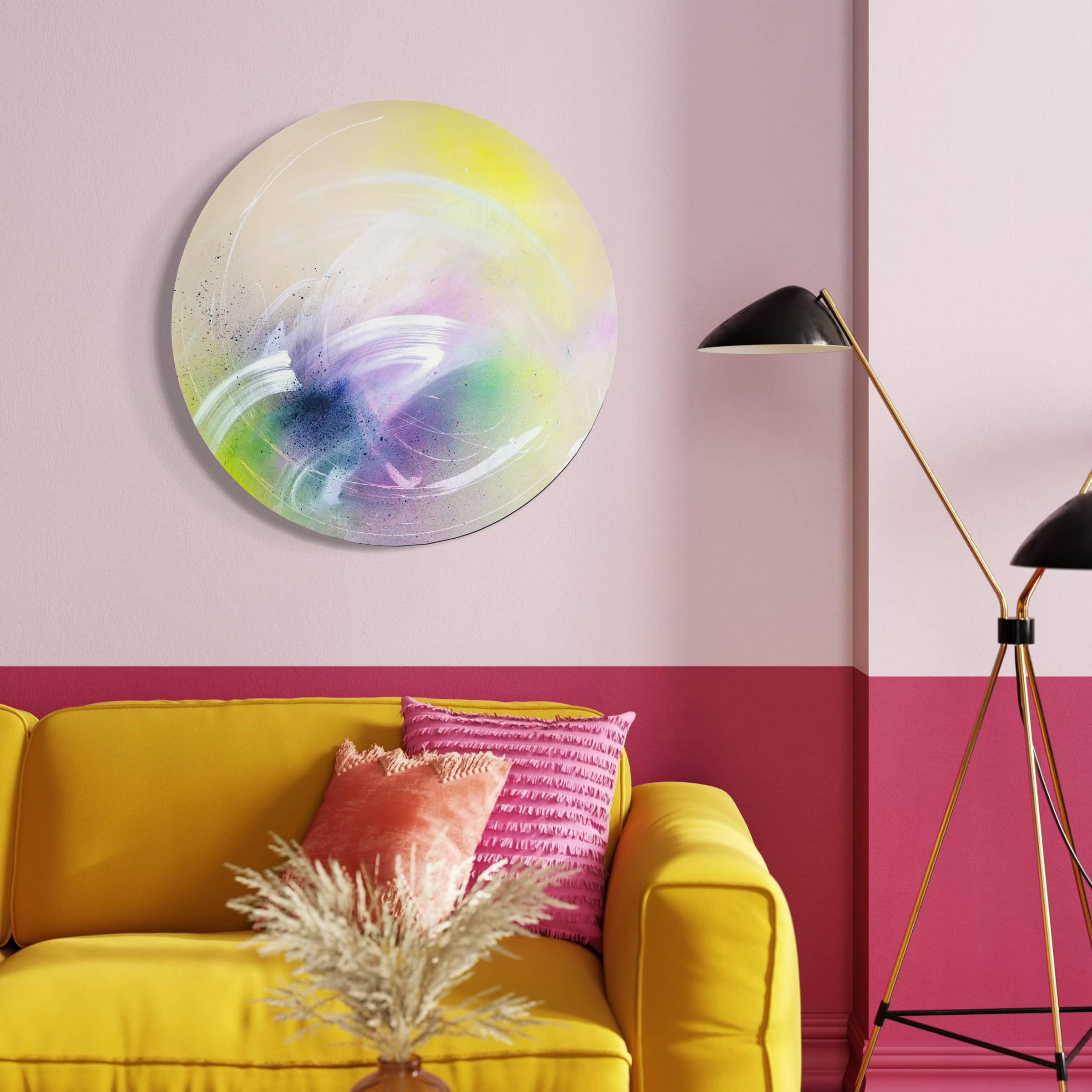 Kate Mayer's painting "I Believe In Miracles" glows on a pink wall above a yellow sofa with pink cushions.