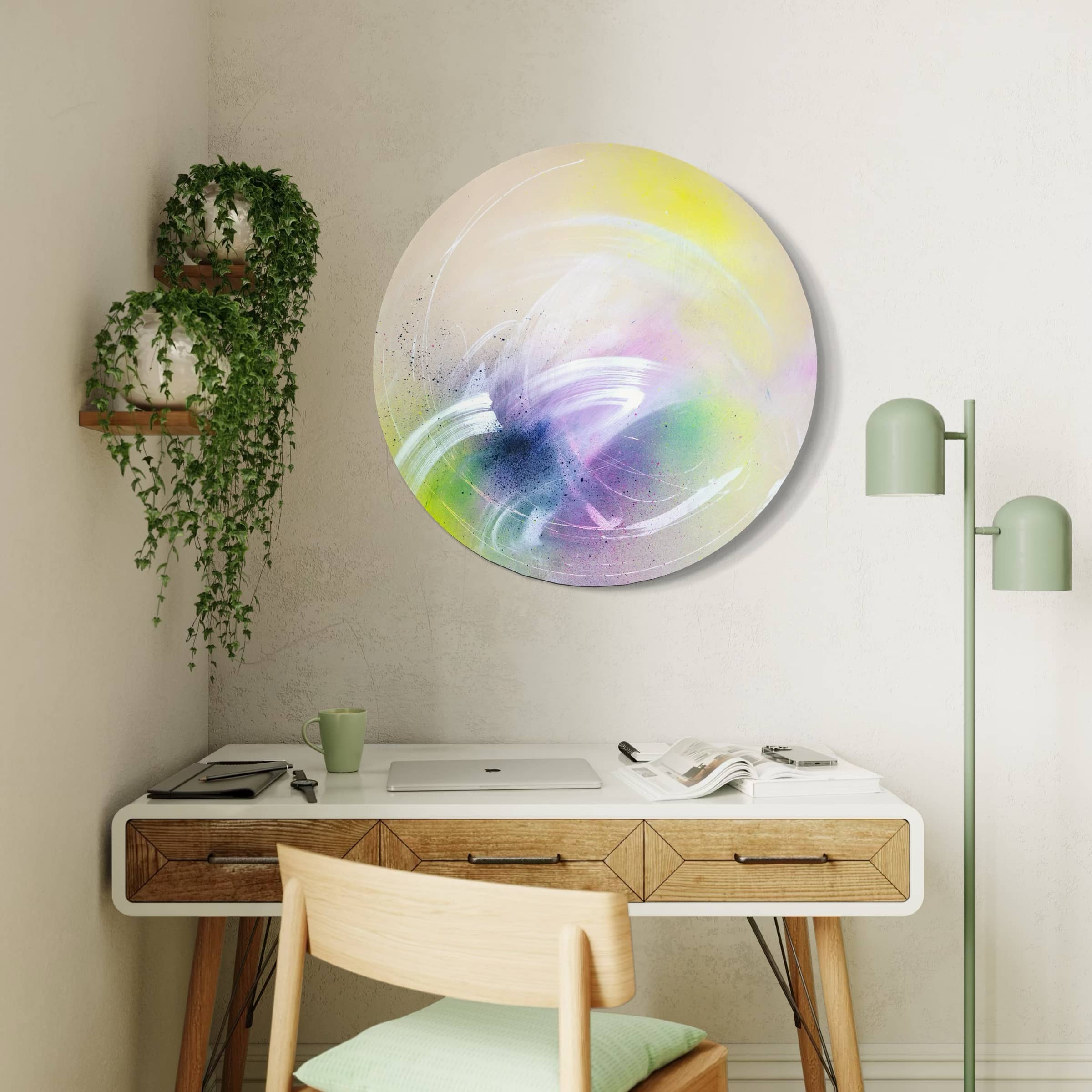 A modern workspace features a wooden desk, lamp, plants, and Kate Mayer's "I Believe In Miracles" abstract painting.