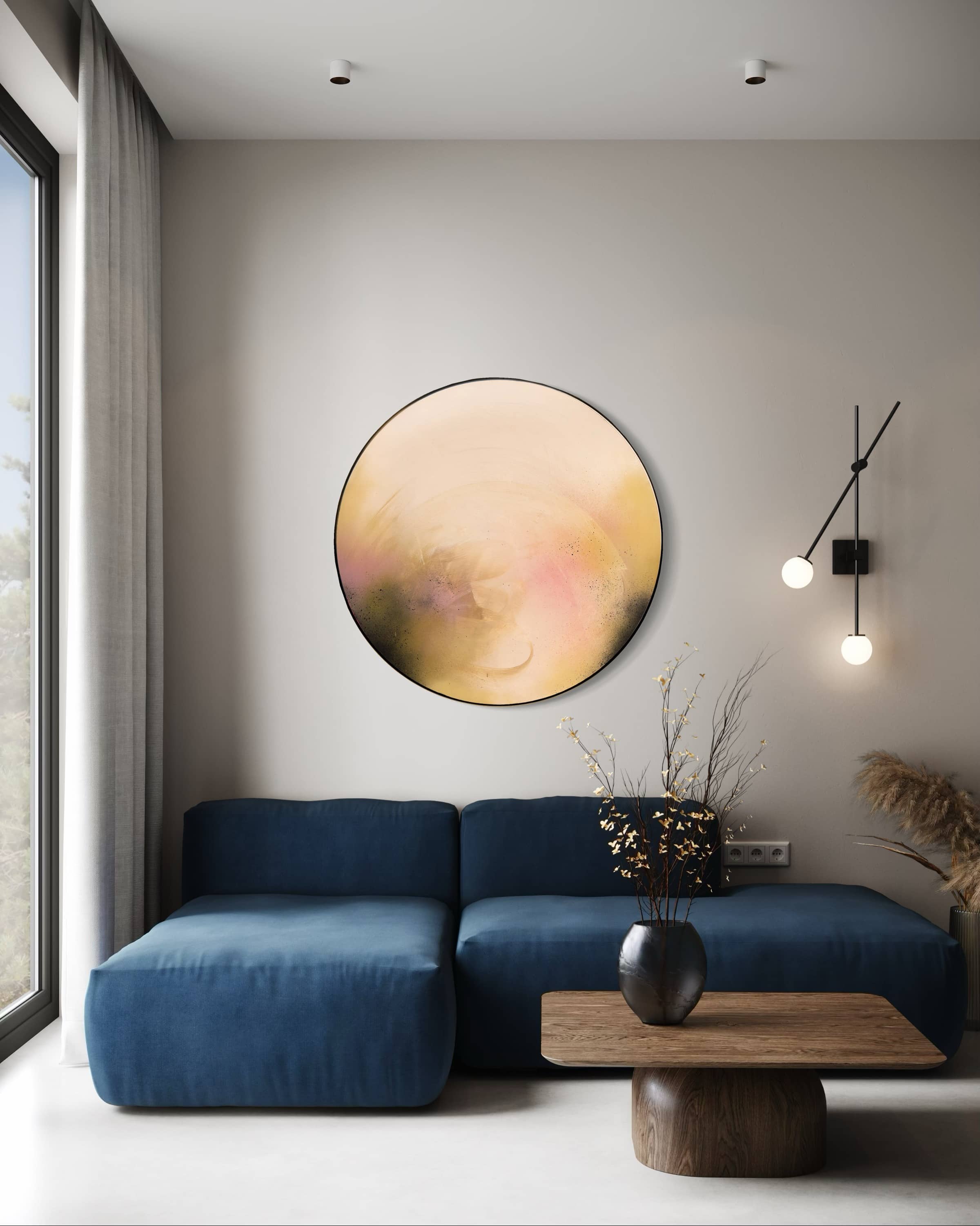 Modern living room with a blue sofa, wooden coffee table, and "You Made The Moon Our Mirrorball" by Kate Mayer.