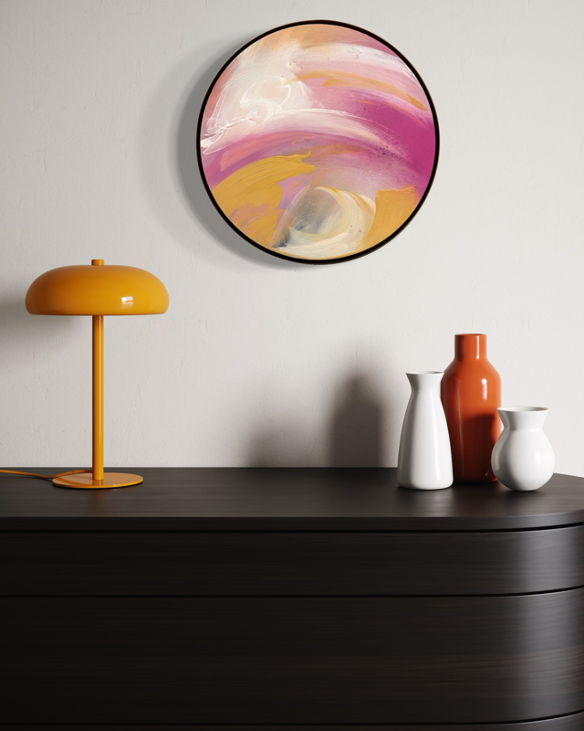 Love’s In Need Of Love Today“ by Kate Mayer—an abstract round acrylic—hangs above a dresser with vases and lamp.