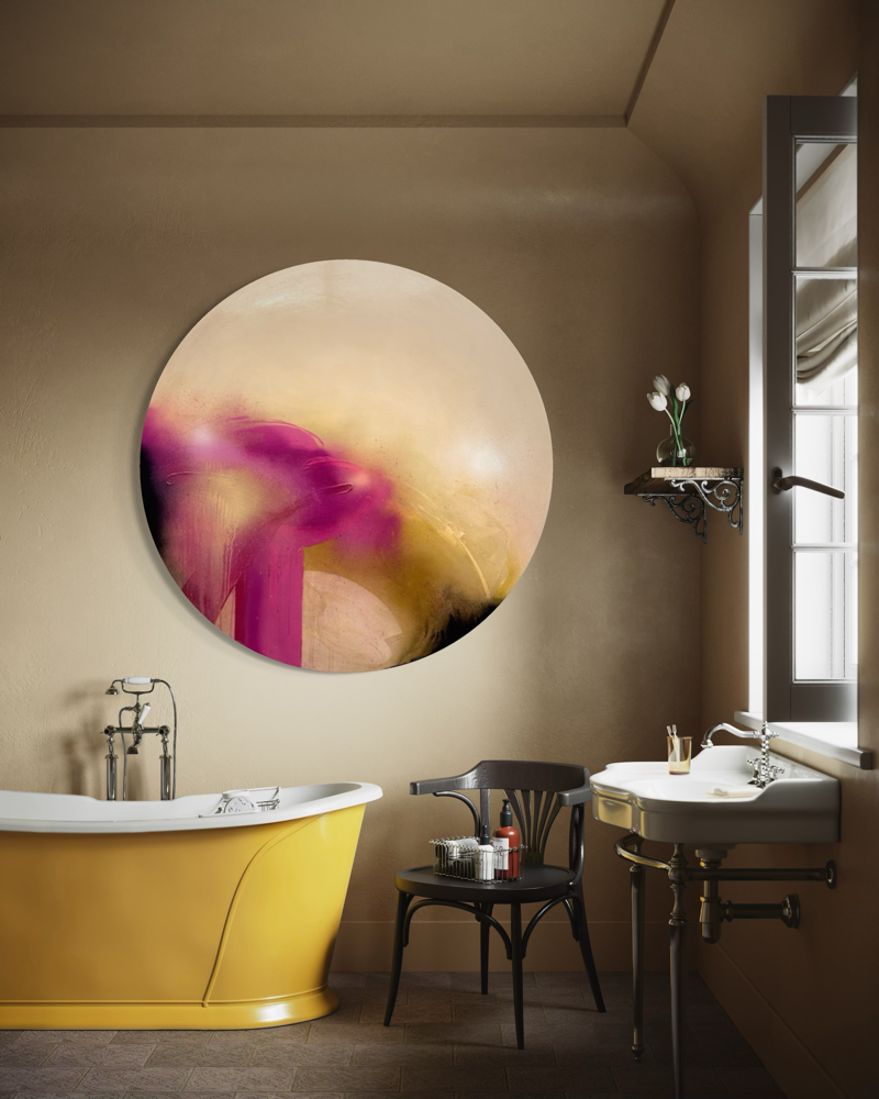 A yellow bathtub sits below the large round “Afterglow” by Kate Mayer in a tan bathroom.