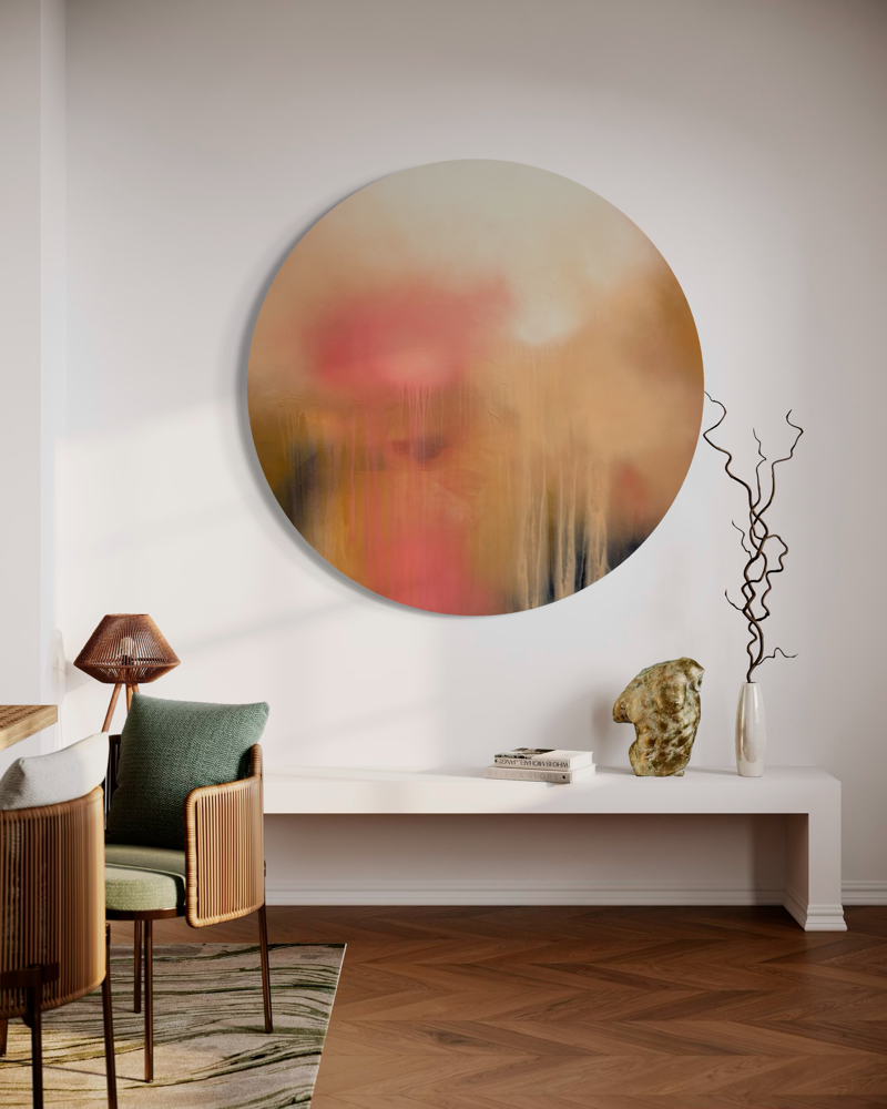 The Afterglow of Awe“ by Kate Mayer, a round abstract painting in a handmade metal frame above a modern console.