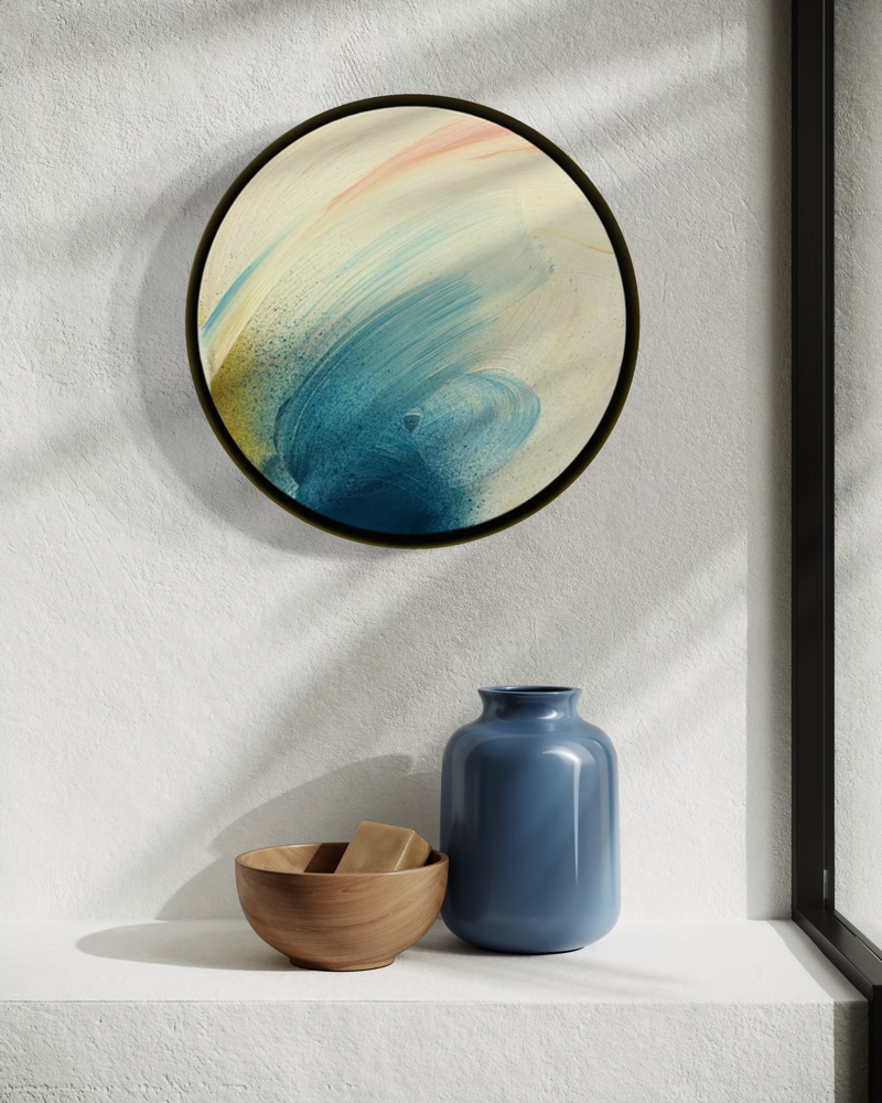 Don’t You Every Give Up by Kate Mayer in a metal float frame above a blue vase and bowl on a sunlit white shelf.