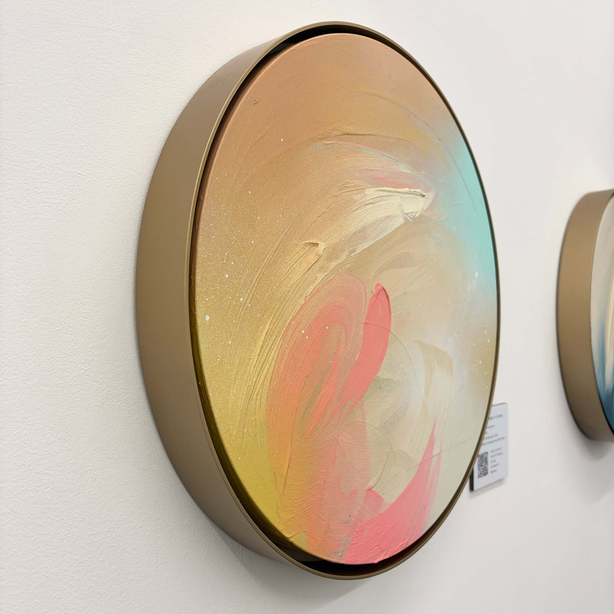 Hold On Change Is Coming“ by Kate Mayer: round acrylic on plywood, swirling pastels, handmade metal frame, labeled.