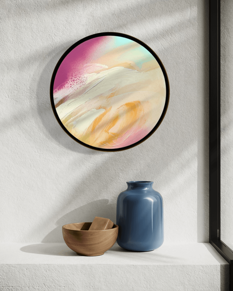 I Smile“ by Kate Mayer—a round pastel abstract in handmade metal frame, above blue vase & wooden bowl on white shelf.