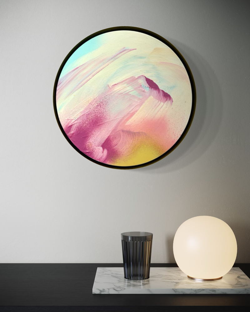 The Power Of One“ by Kate Mayer: round acrylic on plywood in pastels, shown above marble slab with glowing orb lamp.