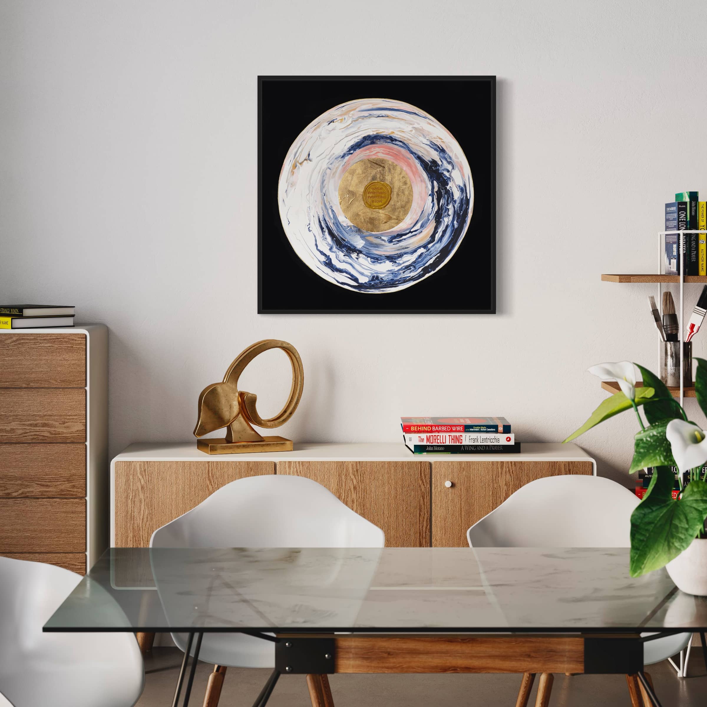 Modern dining room with a glass table, white chairs, and Kate Mayer's original painting "Love Sublime" adorning the wall. Books and a sculptural decor piece sit gracefully on a wooden sideboard.