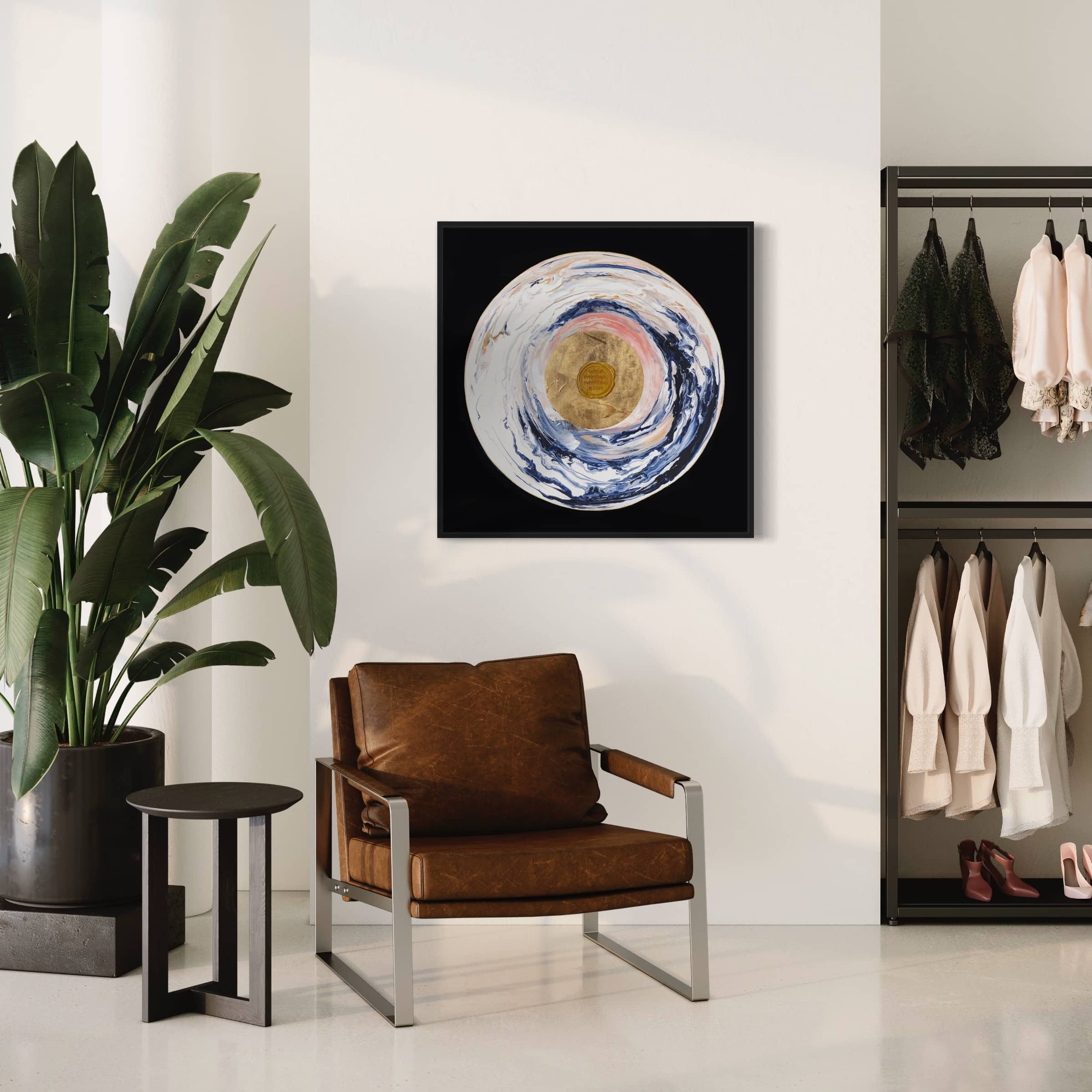 A stylish living space featuring a leather chair, a side table with a plant, and Kate Mayer's "Love Sublime," an original abstract painting with acrylic and gold leaf, wall-mounted above the chair.